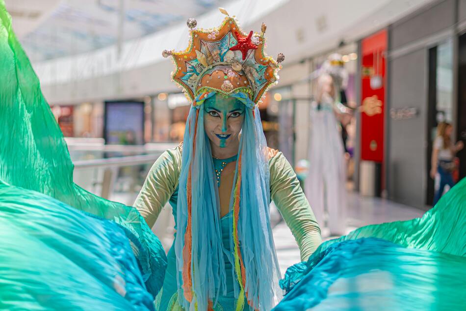 A woman wearing Halloween mermaid makeup and costume.